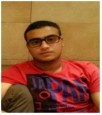 Fadhel Ali is sitting face on, wearing a red tee-shirt