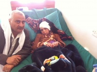 Ali bin Ali Aeta president of the Commission for Social and Labour Affairs in Rada&#039;a visits girl injured by car bomb