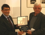 In the absence of 2015 laureate, Talib Al Mamari, Rachid Mesli (left) gives award to Ueli Leuenberger (right)