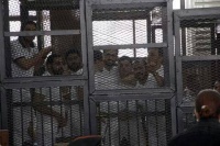 Journalists behind bars during a hearing before the Cairo Criminal Court