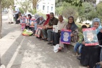   
Algerian women showing pictures of disappeared relatives